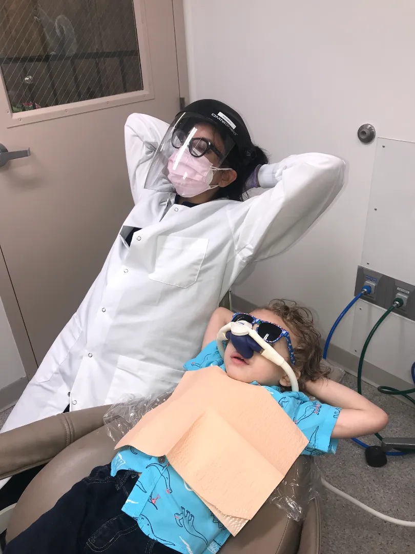 A Dental Care Kids clinician monitoring a young patient during treatment