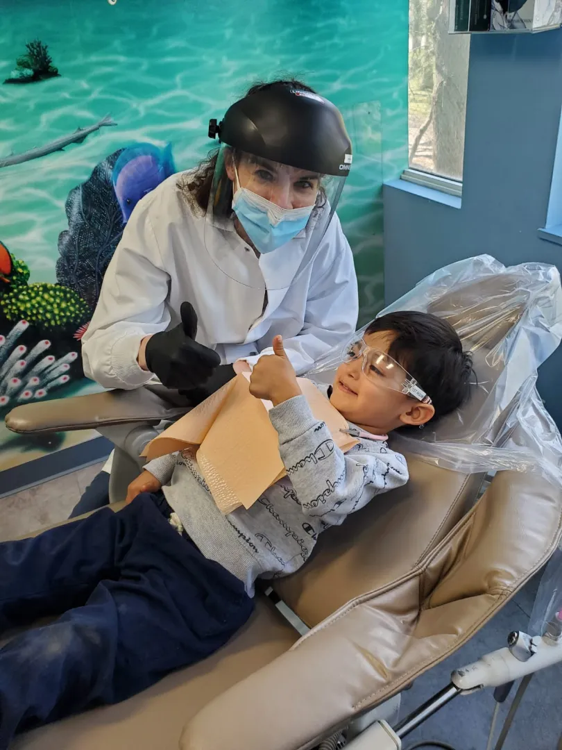 A young Dental Care Kids patient with an activity during his visit