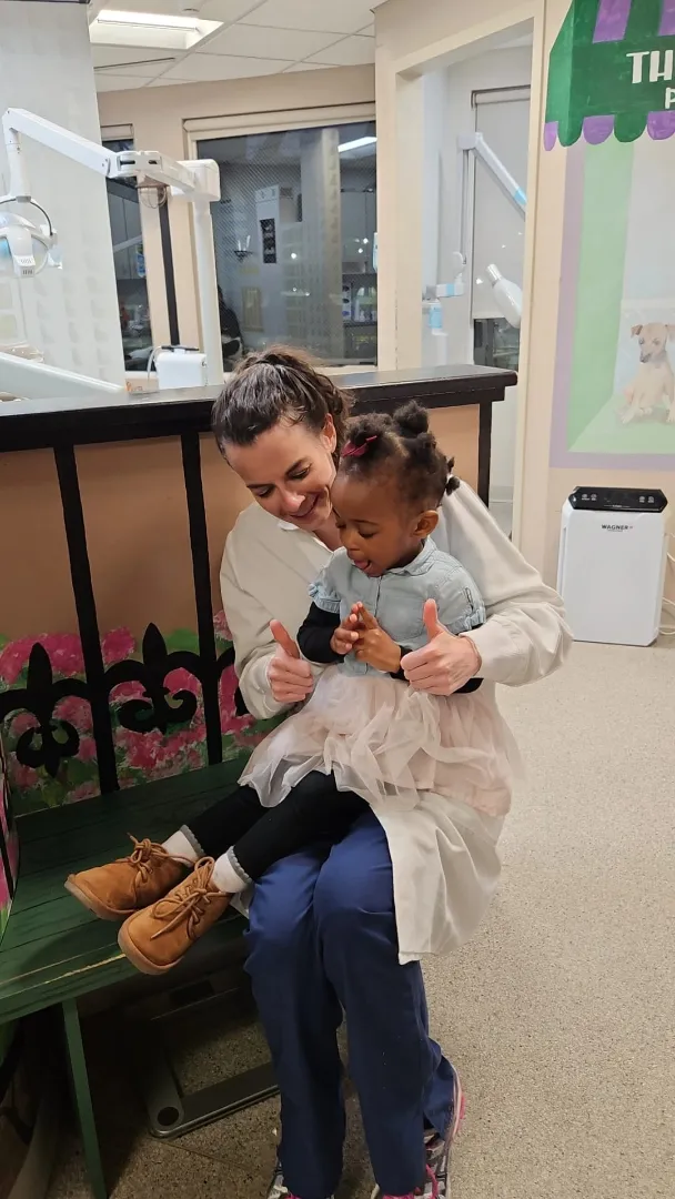 A Dental Care Kids team member greeting a young patient