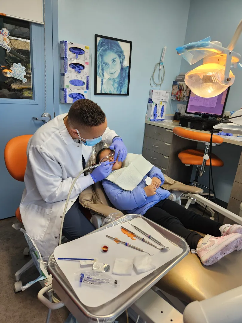 A Dental Care Kids dentist carrying out treatment in the operatory