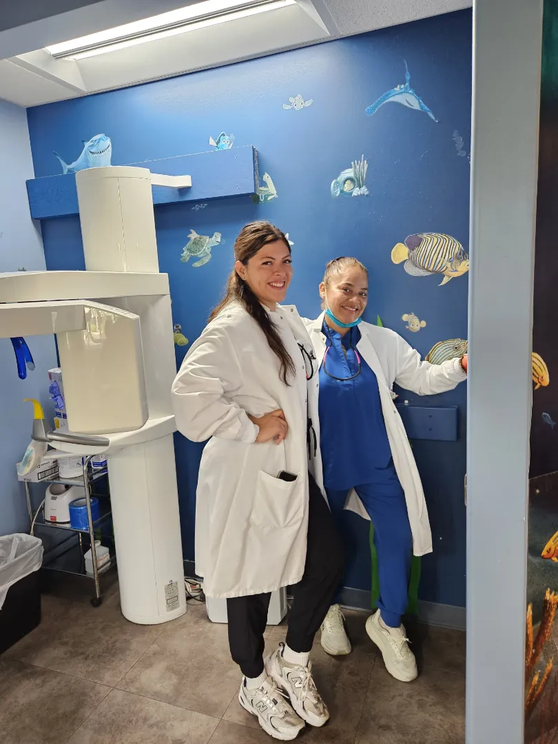 A Dental Care Kids clinician in a mural-painted treatment room