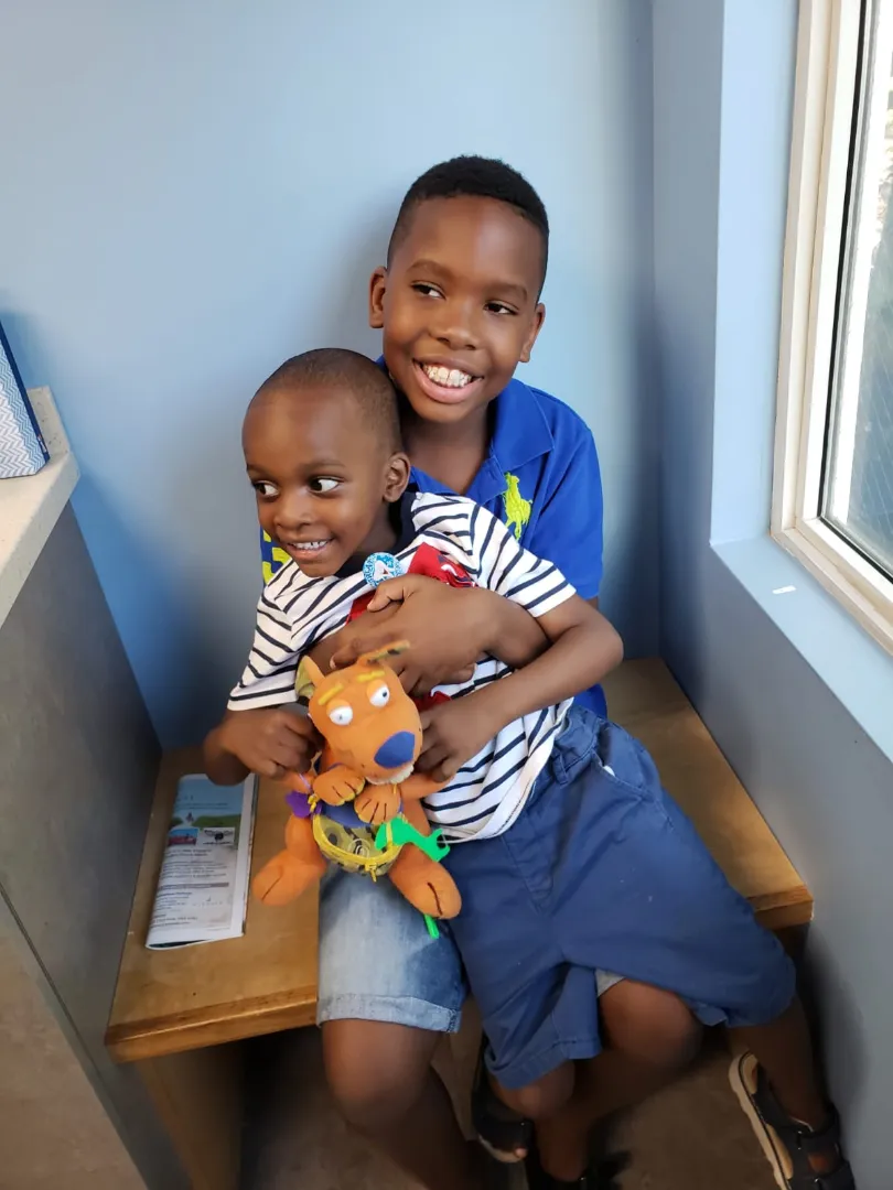 A young Dental Care Kids patient holding a toy after his visit