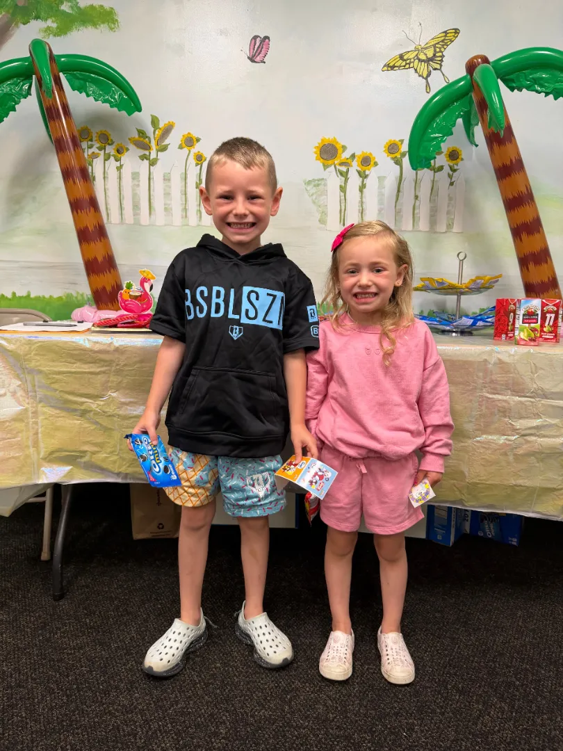 Two Dental Care Kids patients at the prize table