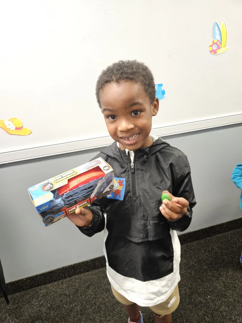 A young patient showing off the toothbrush kit he picked after his appointment