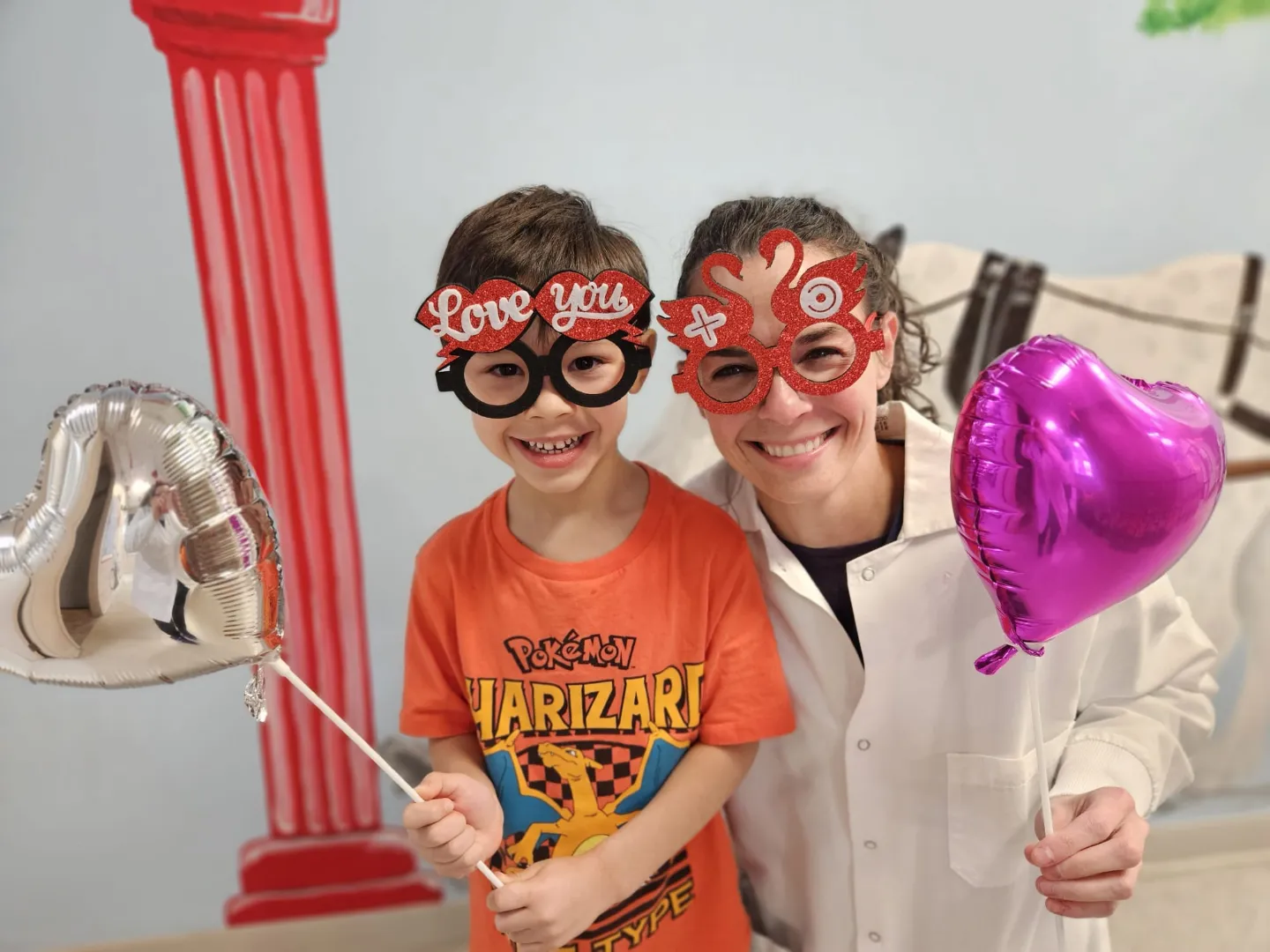 Dental Care Kids patients wearing fun glasses and holding a balloon