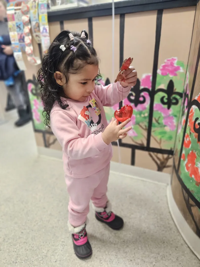 A young Dental Care Kids patient exploring the wall activities
