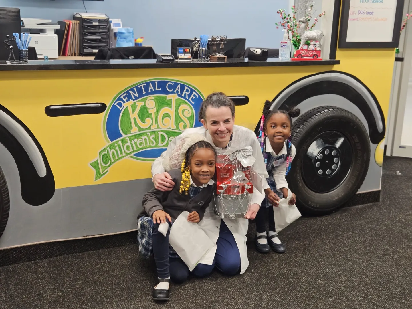 Dental Care Kids patients playing by the practice school bus
