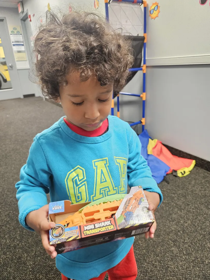 A young Dental Care Kids patient with an activity during his visit