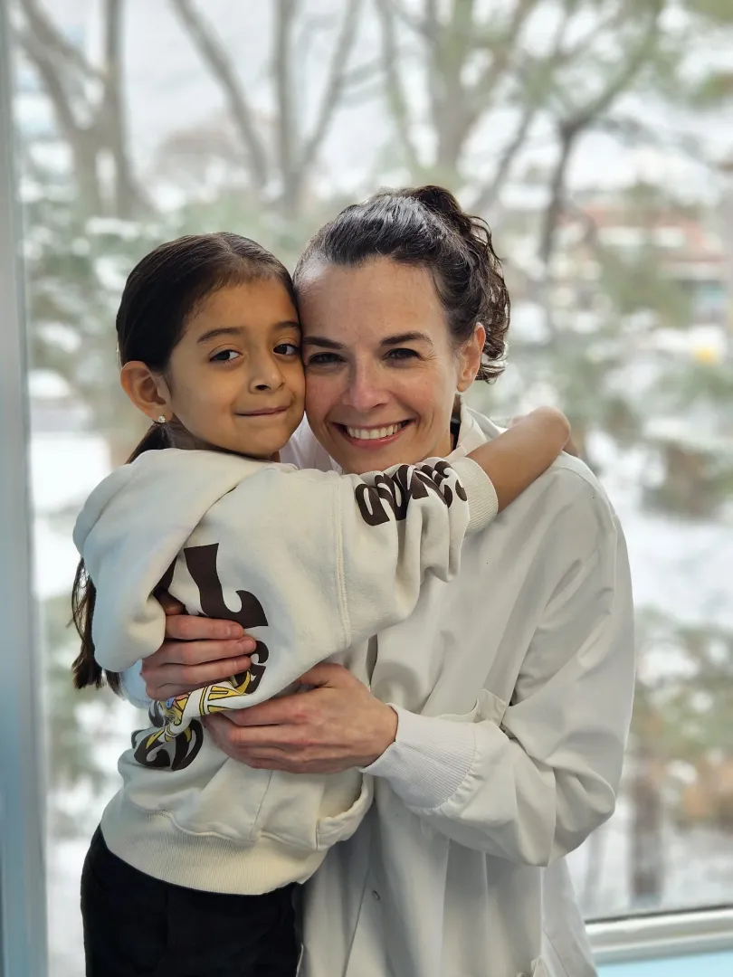 A Dental Care Kids patient and team member smiling together