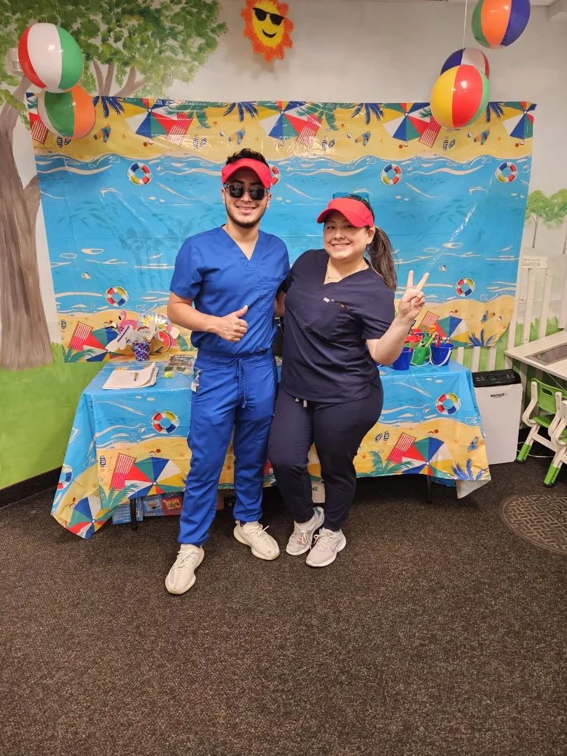 Dental Care Kids team members at the beach-themed activity table