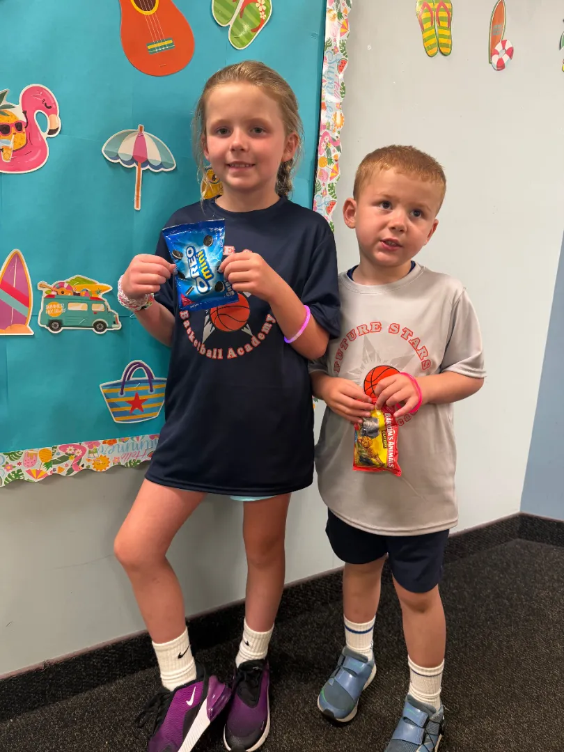 Two Dental Care Kids patients with the prizes they chose after their visit