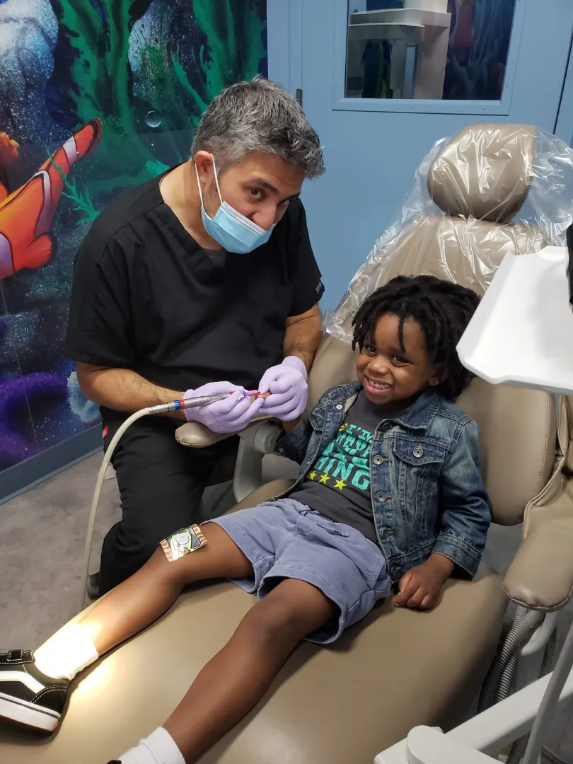 A Dental Care Kids clinician working calmly with a young patient in the chair