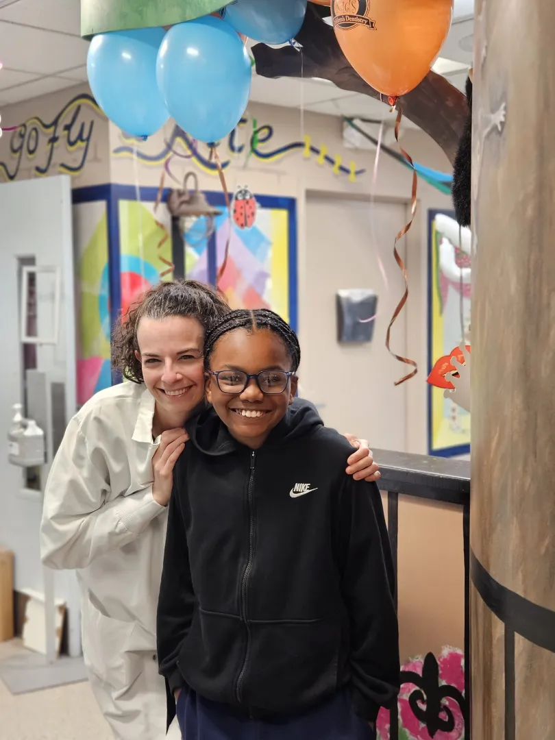 A Dental Care Kids patient and team member smiling together