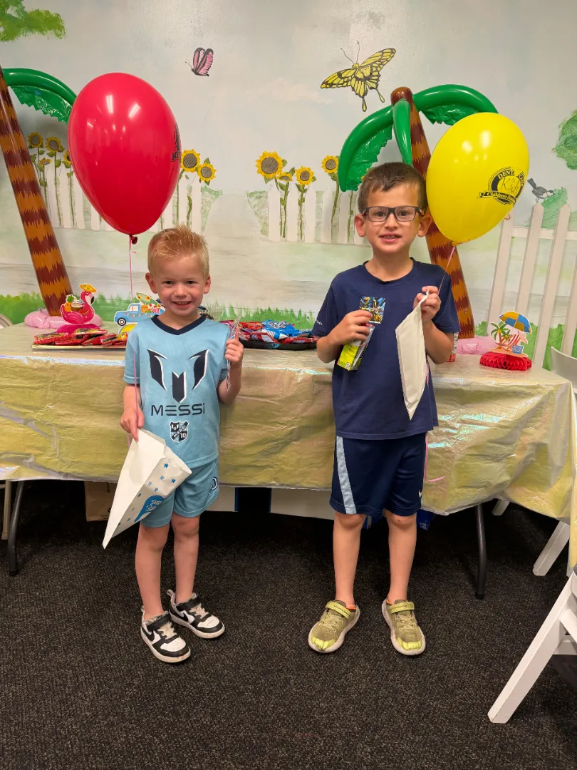 Two Dental Care Kids patients at the prize table after their visits