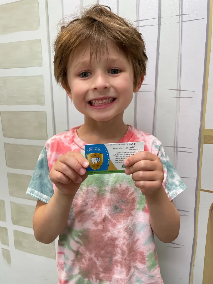 A Dental Care Kids patient showing the sticker she earned