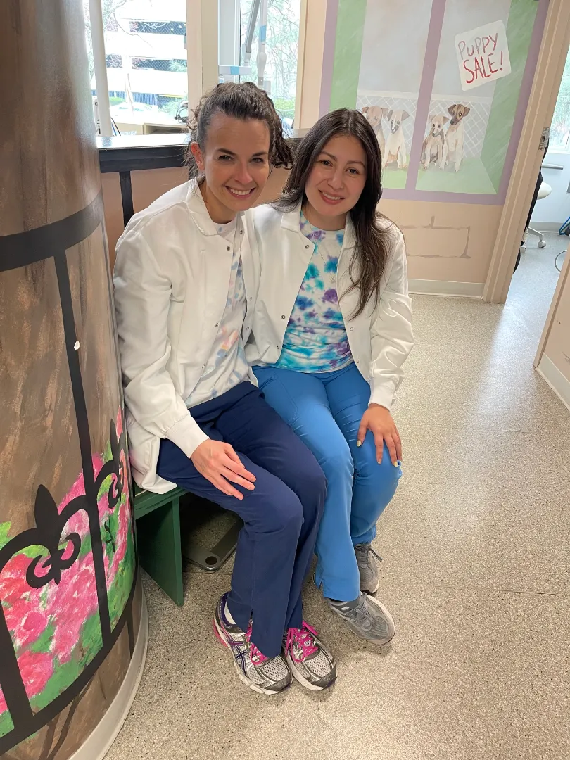 A Dental Care Kids team member seated with a young patient before treatment