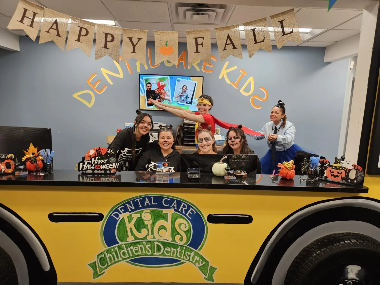 Dental Care Kids pediatric team in playful orange costumes