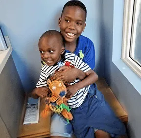 Happy siblings smiling together at Dental Care Kids